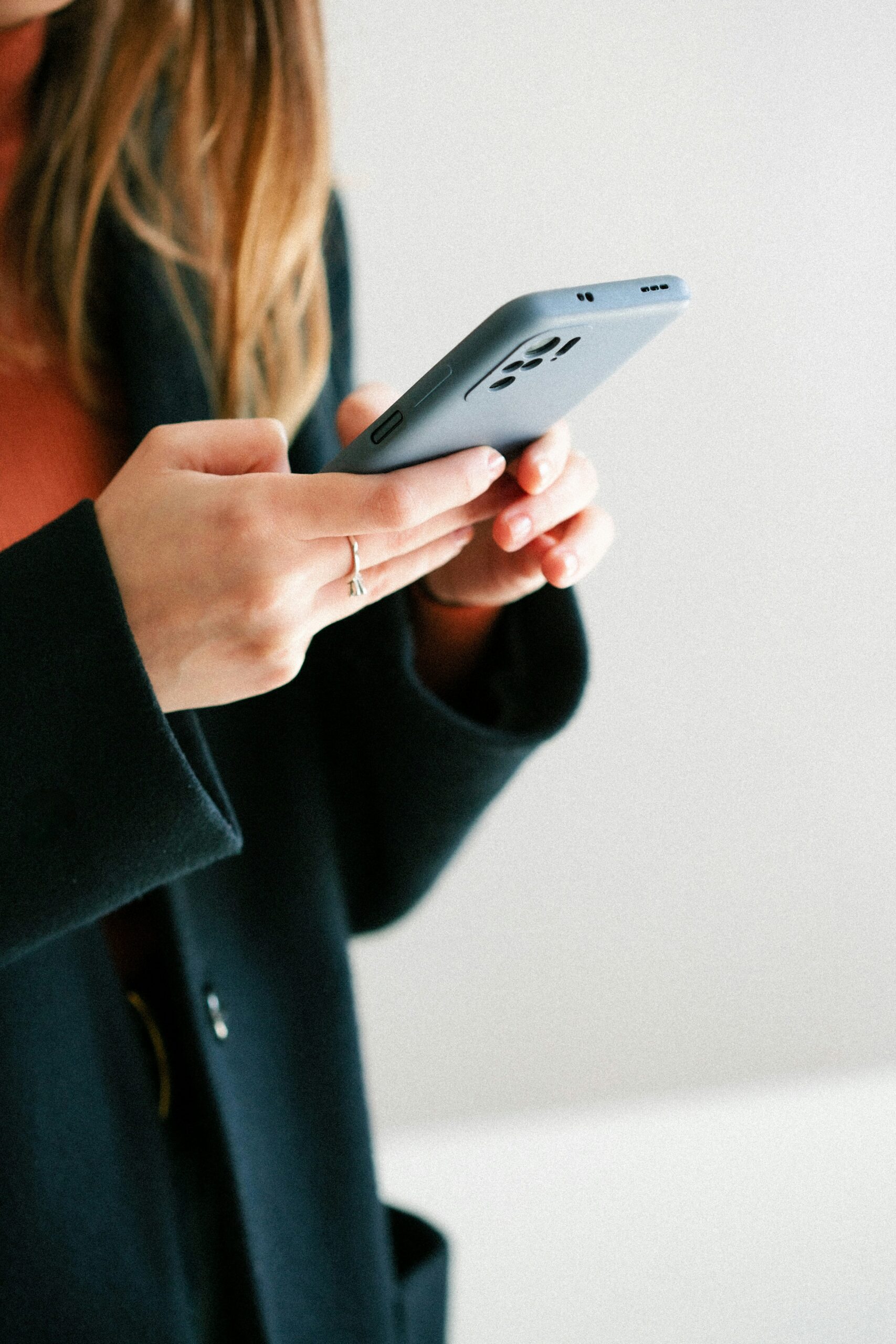 A woman sending an email from her phone