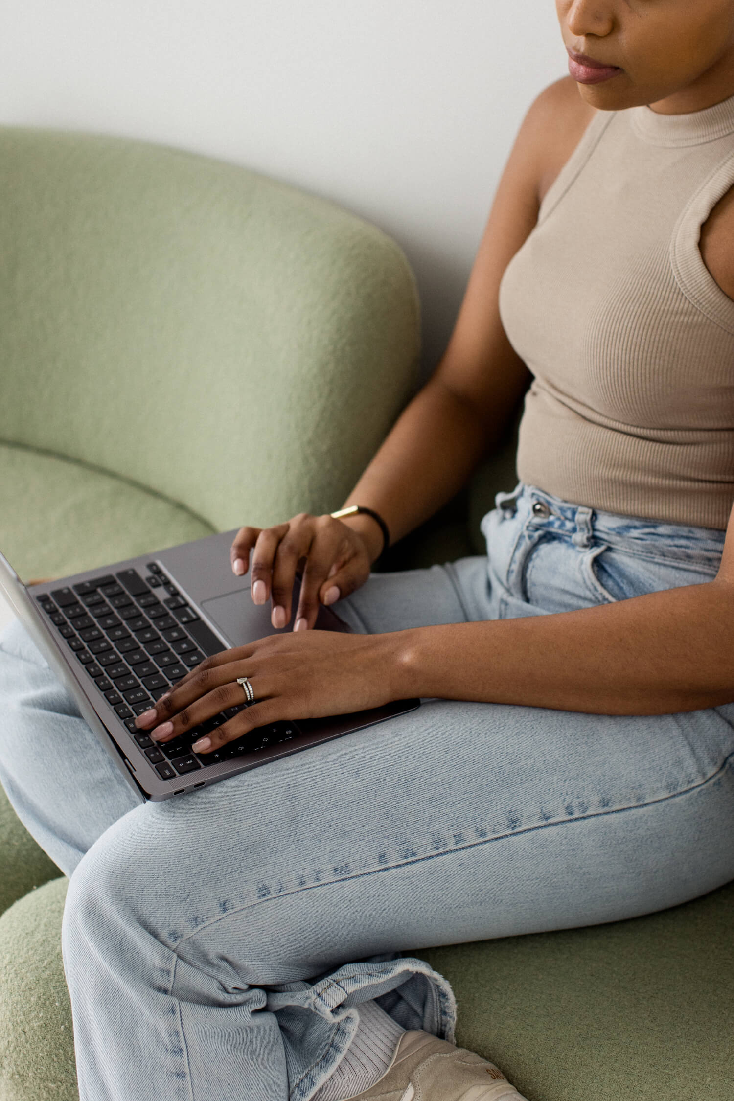 woman working with a laptop on her lap