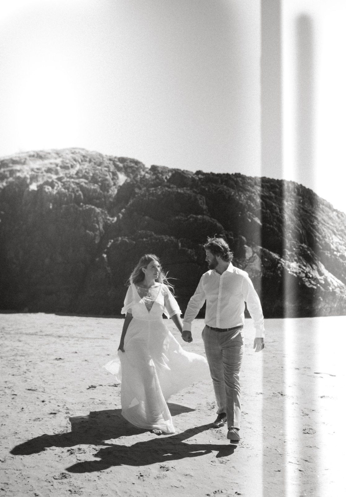 Black-and-white photo of a couple walking together outdoors