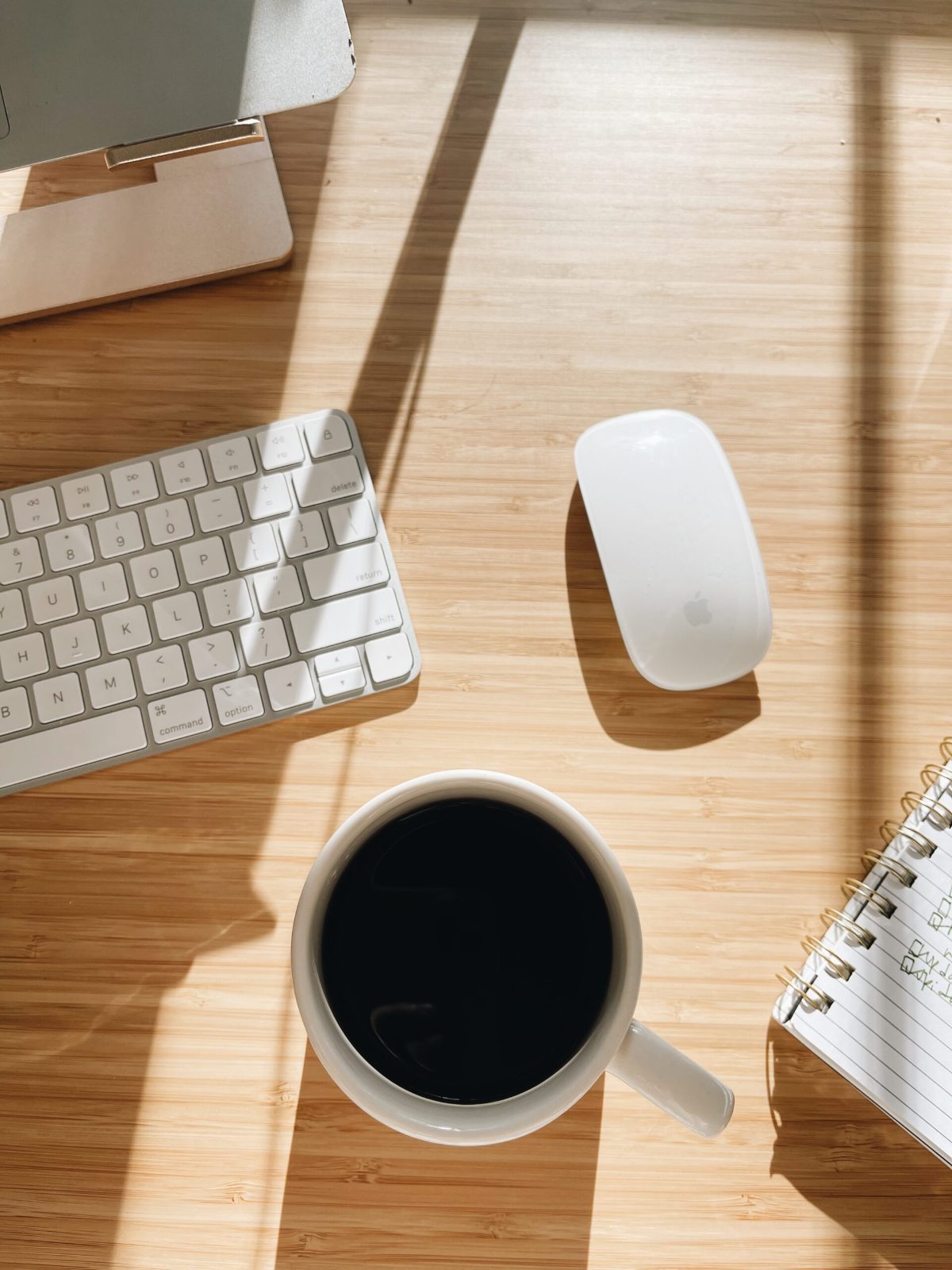 Overhead view of a desk with a keyboard, mouse, and coffee